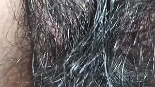 Close up view on a hairy and creamy pussy