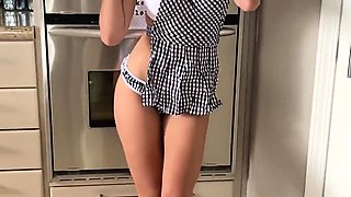 Stunning housewife flaunting her perfect body in the kitchen