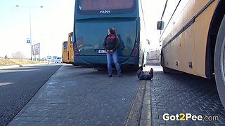 Dirty-minded brunette pulls down jeans to pee at the bus depot