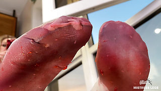 My Nylon Feet Squeezing Strawberry Juice on a Glass Table