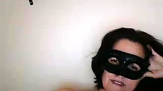 Masked brunette milf has fun with sex toys on the webcam