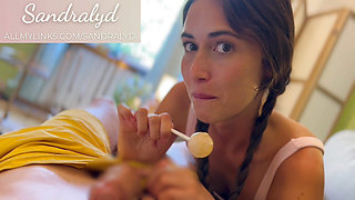 Girl blows with lollipop