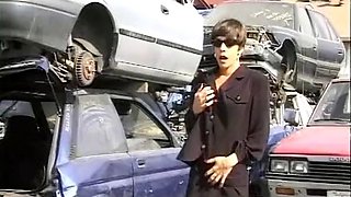 Short-haired German babe getting fucked by two hard cocks at the car waste