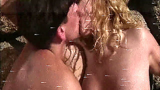 She Lies Naked on the Beach While He Watches Her