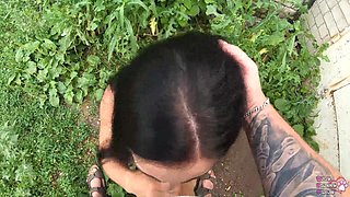 Horny student gives blowjob behind garages