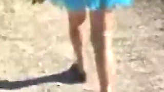 Mel walking on the side of the road