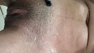 Brunette takes a shower and shaves