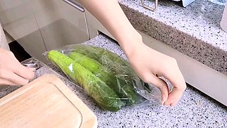 Buxom Chinese beauty teases with vegetables in the kitchen