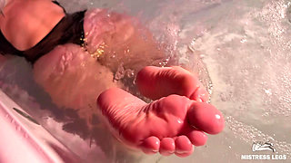 Mistress Teases in the Jacuzzi with Bare Wrinkled Feet and Delicious Ass