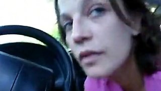 A guy gets sucked by a nice looking brunette inside the car