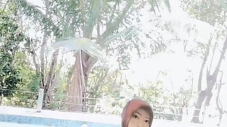 Hijab-wearing Woman Bathes Naked in an Open Swimming Pool