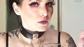 Tattooed gothic lady smoking in the kitchen