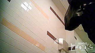Blonde girl pissing in the toilet on the
