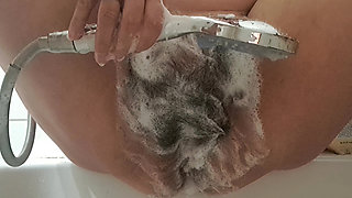 Masturbation with water dripping into the vagina of a mature MILF