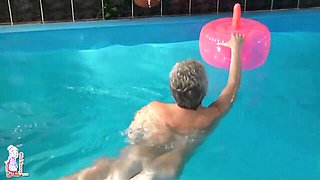 Gorgeous mature blonde Jitka is touching her shaved pussy in the pool