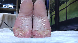Slick oiled wrinkled soles closeup