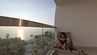 Cute Asian in Black Lace Lingerie Sways Hips on Oceanfront Balcony