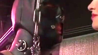 Humiliating man in gas mask
