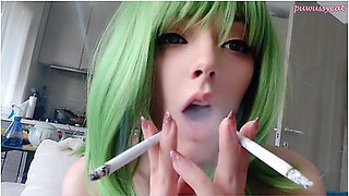 Green-haired girl smokes two cigarettes at once