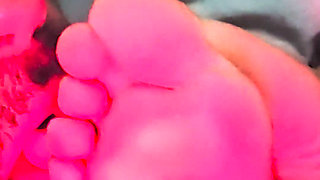 Sucking her toes while she watches a movie