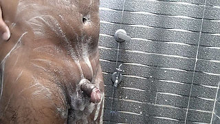 The cock stood up while taking a bath
