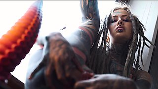 Gorgeous tattooed girl fucks her ass with a big dildo